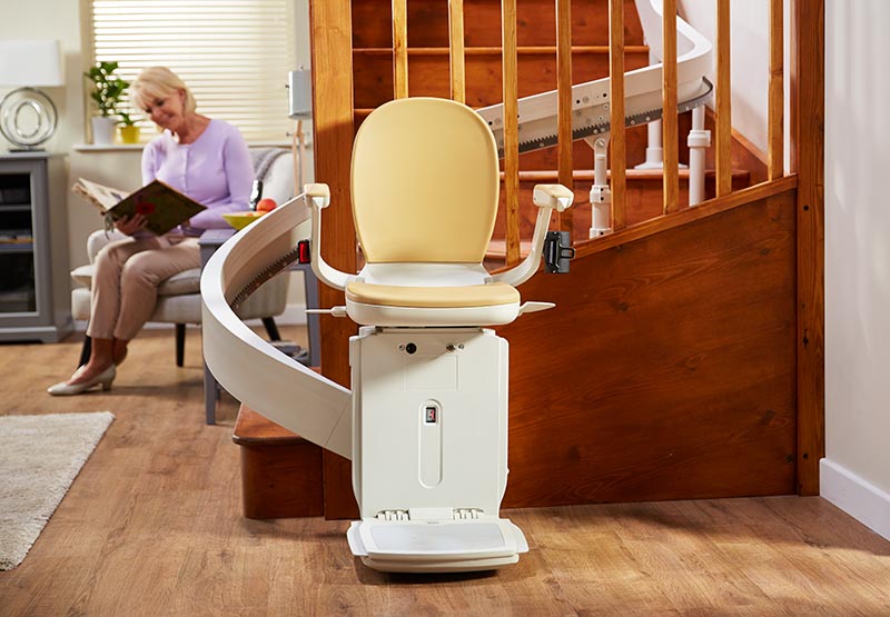 curved stairlift with couple in background