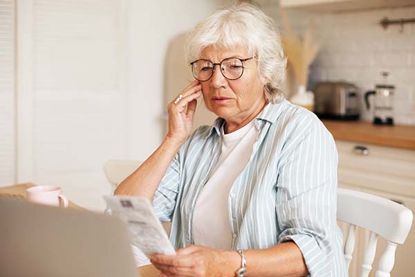 elderly person reading pamphlet for stairlifts 