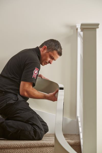 Acorn installer installing a stairlift into a clients house